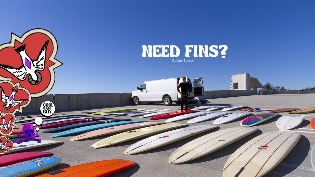 Need Fins? banner ad featuring CJ Nelson standing outside of his van reviewing 50 surfboards he laid out in the parking lot. Order now.