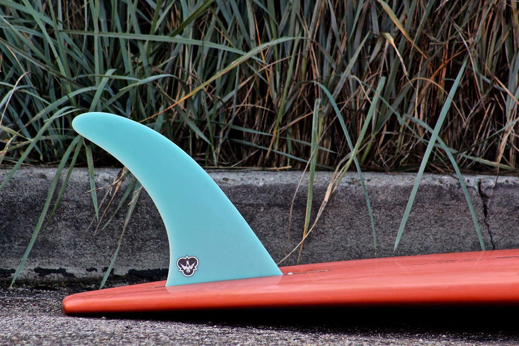 A sky blue CJ Power Flex on a red/orange surfboard