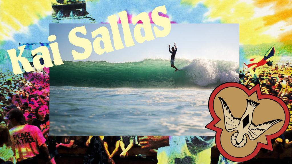 Kai Sallas throws his hands in the air while hanging a perfect 10 on a wave in Hawaii.