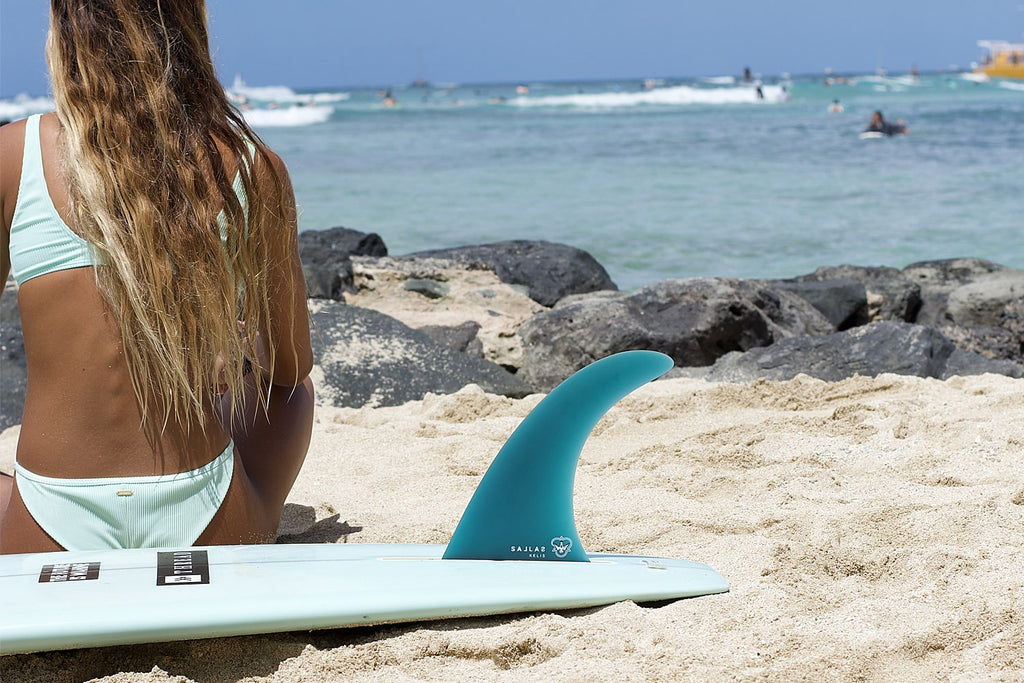 Kelis Kaleopa'a checks out the waves with her board featuring the new fin model. 
