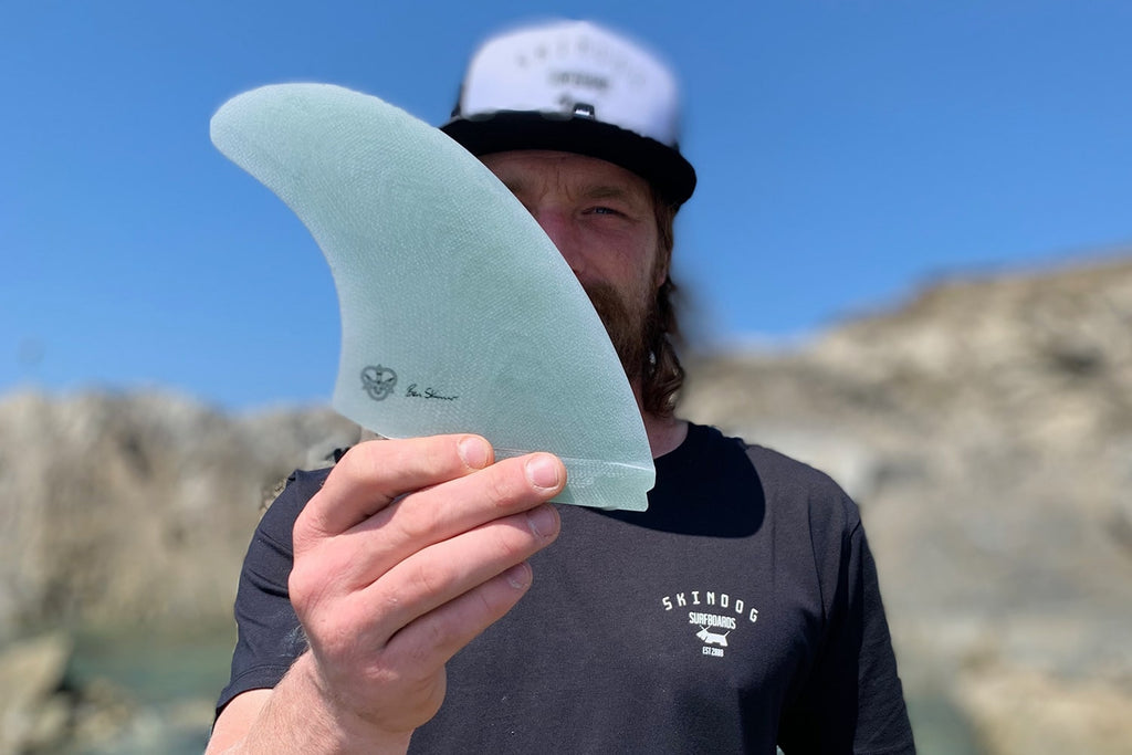 Close up of Ben Skinner holding his twin fin model.