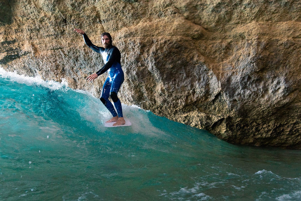 Ben Skinner on the nose surfing in a cave.